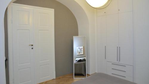 a room with a white door and a mirror at City De Lights in Graz