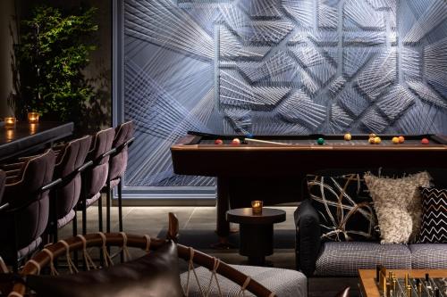 a bar with a pool table and chairs and a pool table at THE LIVELY TOKYO AZABUJUBAN in Tokyo