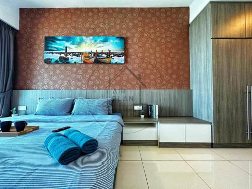a bedroom with a bed with blue pillows on it at PD 4 Bedrooms Duplex - Full Seaview (Up to 16 Pax) in Port Dickson