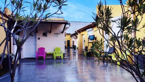 a courtyard with colorful chairs and a table at La Sérénade Numéro 1 in Montreuil
