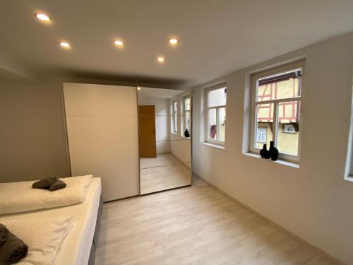 a bedroom with a bed and a hallway with windows at Blick in den Malerwinkel in Marktbreit