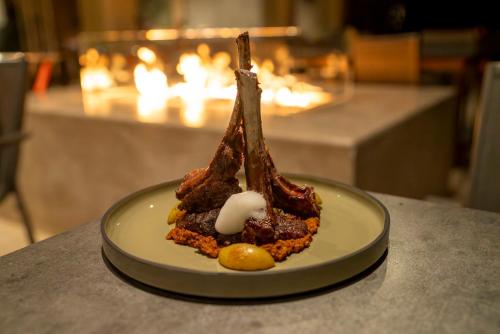 a dessert on a plate on a table at Hotel Indigo La Paz Puerta Cortes by IHG in La Paz