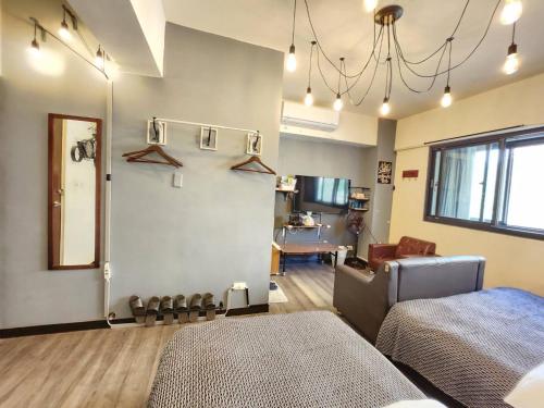 a living room with a bed and a couch at 一中喵喵 有統編收據 禁菸 非自助 in Taichung
