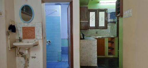 a bathroom with a sink and a toilet and a mirror at Temple Darshan in Chidambaram