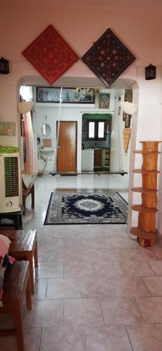 a living room with a rug on the floor at Temple Darshan in Chidambaram