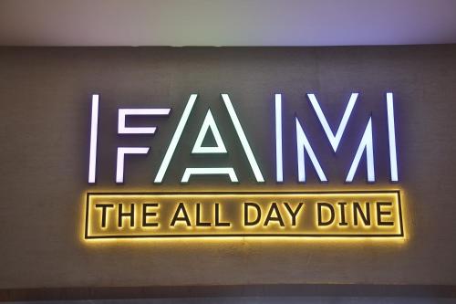 a neon sign that says fame the all day dinner at Regenta - The World Surat in Surat