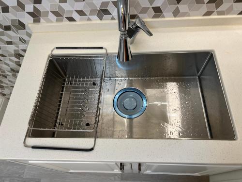 a sink in a kitchen with a faucet at Stay Sheem Nokbeon st 3 min in Seoul