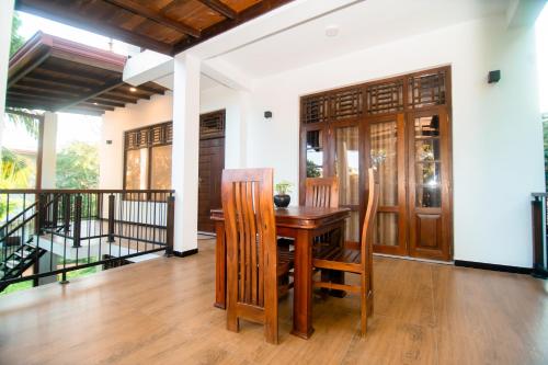 ein Esszimmer mit einem Holztisch und Stühlen in der Unterkunft Dream Villa - Tangalle in Tangalle