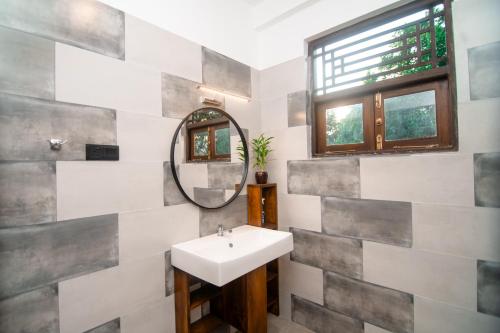 a bathroom with a sink and a mirror at Dream Villa - Tangalle in Tangalle