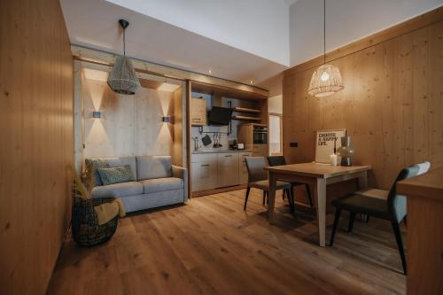 a living room with a couch and a table at FRÄULEIN NANNERL - Boutique Apart mit Saunahaus in Gerlos