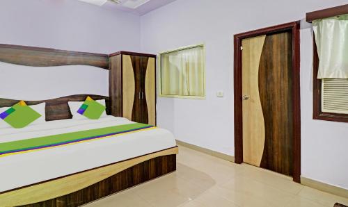 a bedroom with a bed with a wooden headboard at Hotel Golden Glam in Agra