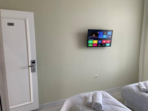 a room with a tv on the wall at Tashkent hotel Parvoz in Tashkent