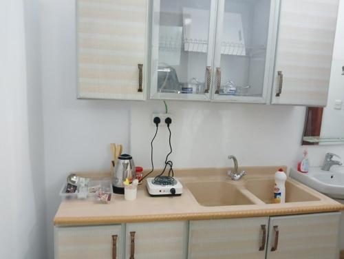 a kitchen with a sink and a counter top at Soma Suites in Al Madinah