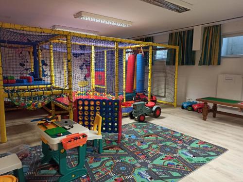 a play room with many different types of play equipment at Familienhotel nahe der Therme Erding in Erding