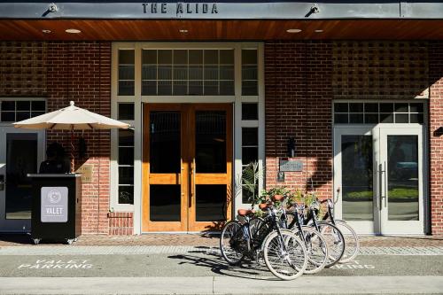a group of bikes parked in front of a building at The Alida, Savannah, a Tribute Portfolio Hotel in Savannah