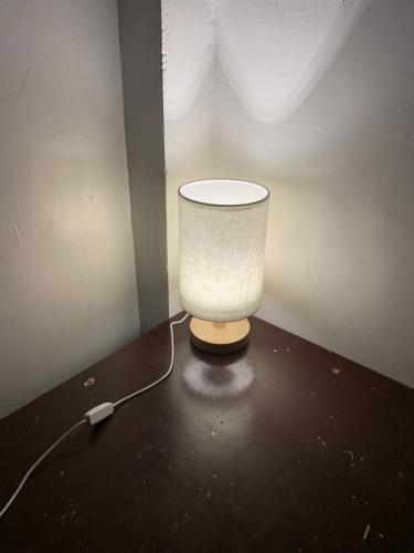 a white lamp sitting in a corner of a room at Dadods homestay in General Luna