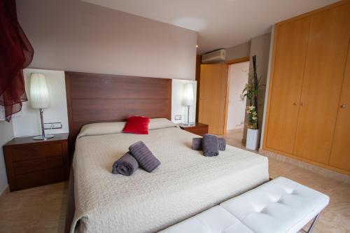 a bedroom with a large bed with two pillows on it at Catalunya Casas Tranquil Paradise, Private Pool and only 200 meters to beach! in L'Ampolla