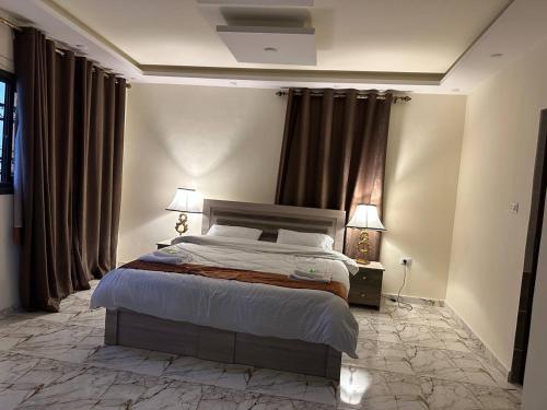 um quarto com uma cama e 2 candeeiros e cortinas em Dream Hotel jerash em Gérasa