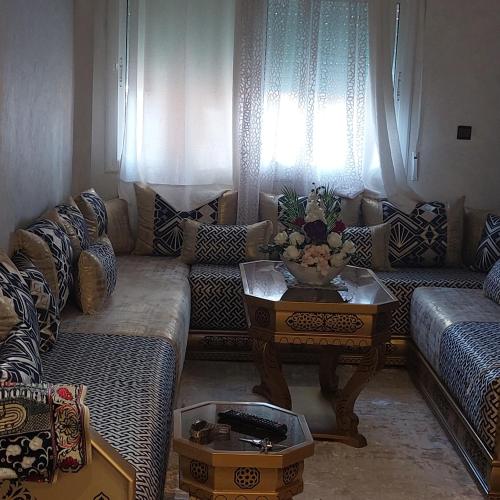 a living room with a couch and a table at Imouzzar kandar in Imouzzer du Kandar