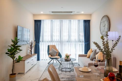 a living room with a couch and a table at Metropole Thu Thiem Condo Apartment in Ho Chi Minh City