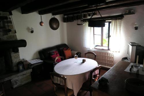 a living room with a table and a couch at Rustico Storelli in Brissago