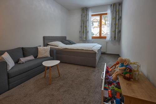 a living room with a couch and a bed at Donovaly Residence Apartment 111 in Donovaly