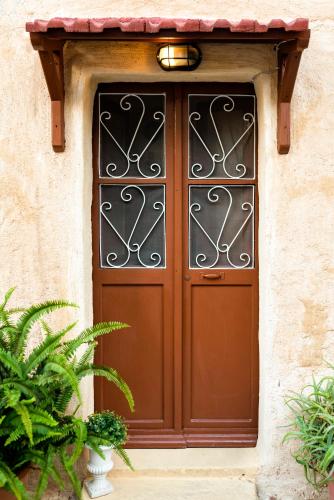 a brown door with a metal gate on a building at Kristina´s rooms in Rhodes Town