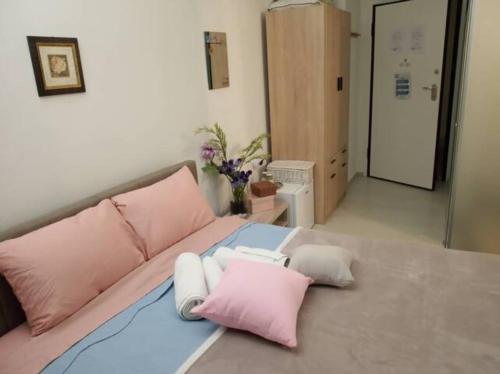 a bed with pink and white pillows on it at CKBSM Athens Center Apartment 2 in Athens