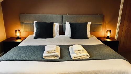 a bedroom with a bed with towels on it at Lacet House in Ambleside
