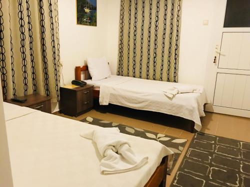 a hotel room with two beds and a towel at Cam Hotel in Gümbet