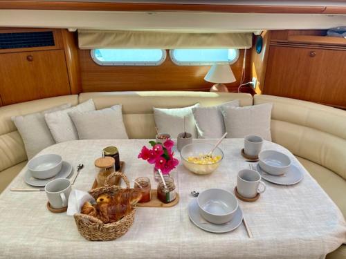 a table with a basket of food on a boat at Jeanneau Sun Odyssey 54 DS LULU’ in Nydri