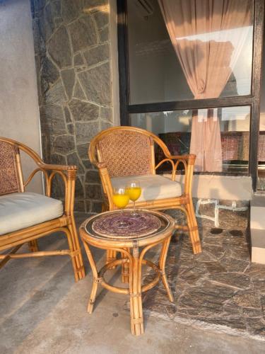 two chairs and a table with two oranges on it at Spice of Ceylon in Chilaw