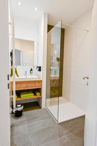 a bathroom with a shower and a sink at Hotel "City Rooms Wels" in Wels