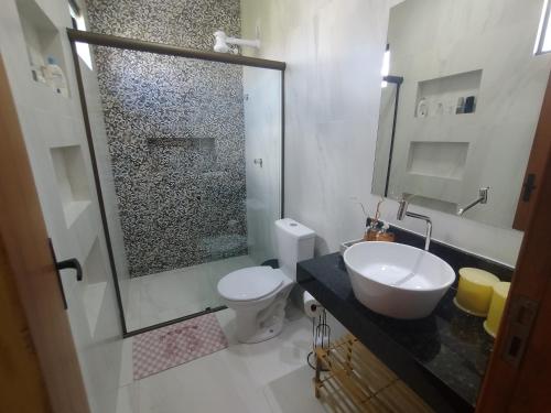 a bathroom with a sink and a toilet and a shower at Lar das Cerejeiras in Bananeiras