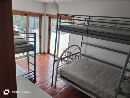 a room with two bunk beds and a balcony at Residencial Monte Gordo Golf Rei Algarve in Monte Gordo