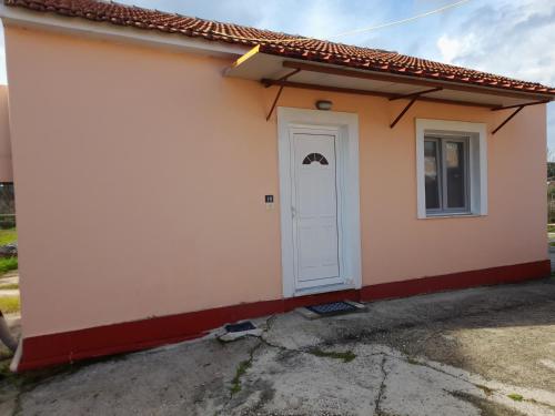 a small house with a white door at Sidari Studios in Sidari