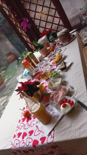 a long table with plates of food on it at Sunshine Suites in Florence