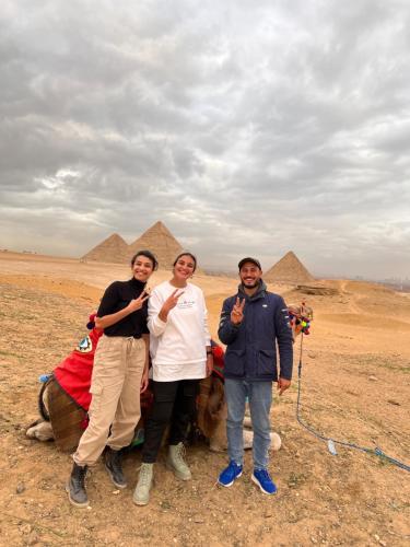 a group of people standing in front of the pyramids at Sahure Pyramid View Inn in Cairo