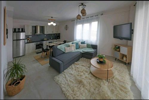 a living room with a couch and a table at Boutique lazou in Neochorópoulon