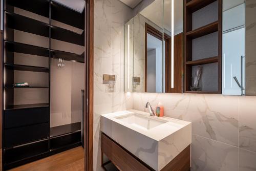 a bathroom with a sink and a mirror at Metropole Thu Thiem Condo Apartment in Ho Chi Minh City