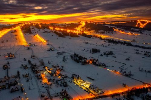 a view of a ski slope at sunset at Panocek i Babka in Białka Tatrzanska