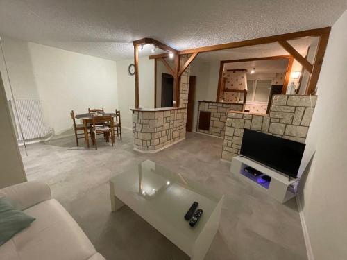a living room with a tv and a fireplace at Appartement motte giron 2 personnes in Dijon