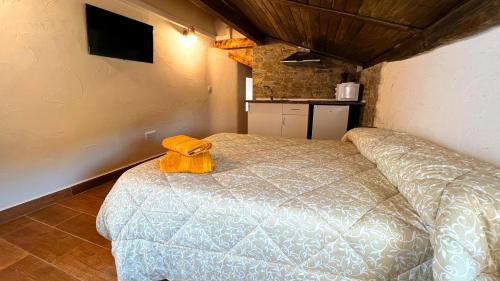 a bedroom with a bed with a yellow towel on it at Estudio o Apartamento Toni in Alcalá del Júcar