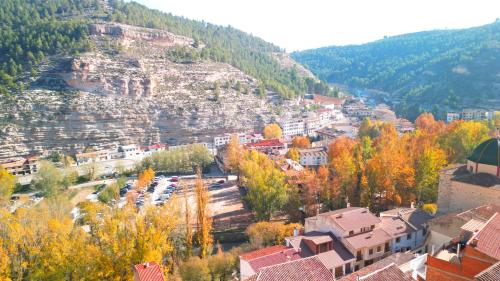 a town in the mountains with trees and buildings at Estudio o Apartamento Toni in Alcalá del Júcar