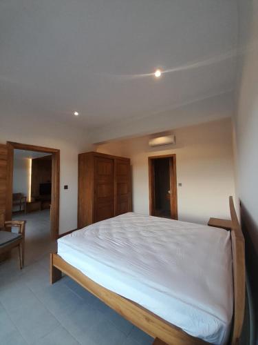a bedroom with a large white bed in a room at Paille en Queue apartment in Grand Baie
