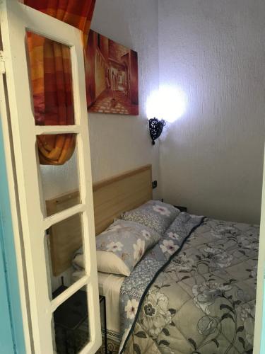 a bedroom with a bunk bed and a ladder at Riad chez brahim in Essaouira