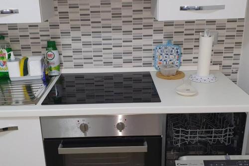a kitchen counter with a sink and a stove at alloggio belvedere & relax in Macchia Valfortore