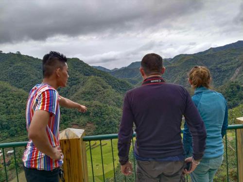a group of people looking at the mountains at BANAUE EVERGREEN HOSTEL AND RESTAURANT in Banaue