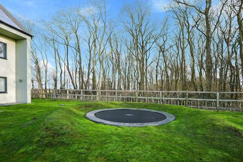 a circle in the grass next to a fence at Spacious 4 bed home with gym and tennis court in Lincoln