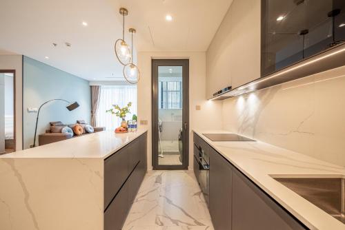 a kitchen with marble counter tops and a sink at Metropole Thu Thiem Condo Apartment in Ho Chi Minh City